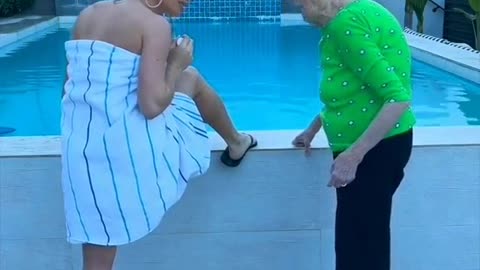 Funny sexy girl at the pool with the grandmom