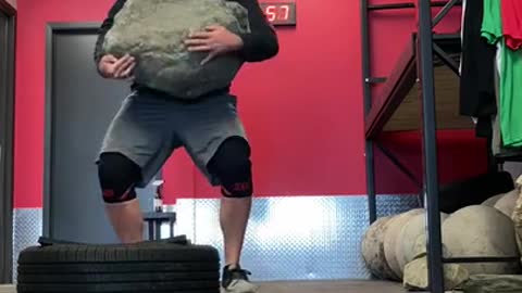 Guy Shows His Strength by Lifting Huge Rock