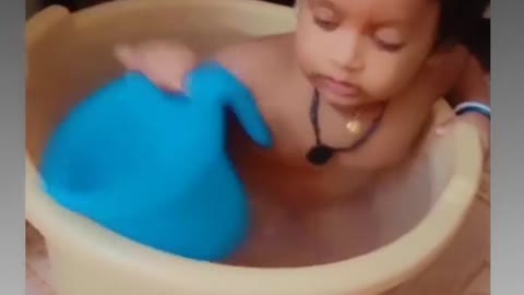 Cute baby swimming in baket