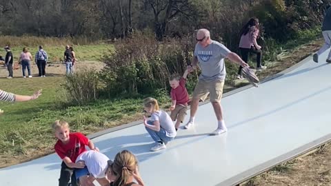 Man Thinks on His Feet to Avoid Collision on Slide