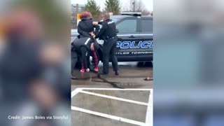 Video shows police officer punching woman