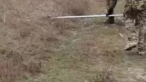 Wagner soldiers remove an anti-tank mine with a canoe oar