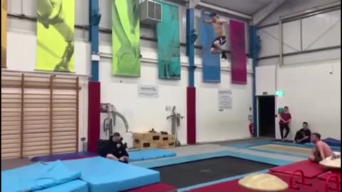 Dude Performing Front Flips On Trampoline