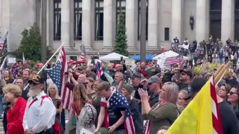 Thousands gathered outside the Washington State Capitol singing the National Anthem