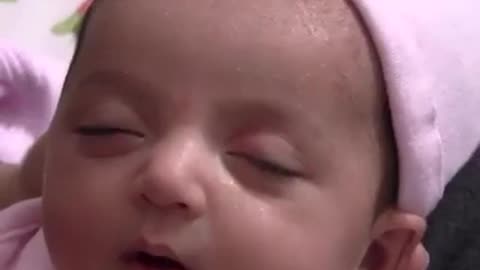 Very cute baby smiling when sleeping