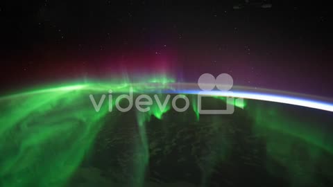 The International Space Station Flies Over The Earth With Aurora Borealis Visible 1