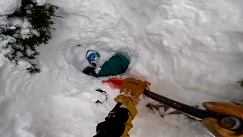 Moment skier digs out snowboarder buried under snow