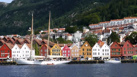 sailboat in front of bryggen the dock tyskebryggen buildings at the vagen harbour in bergen norway