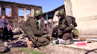Pro-Russian service members inspect Mariupol