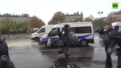 Activists spray yellow paint on Champs-Elysees, marking five years of Yellow Vests