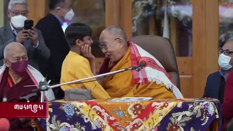 Dalai Lama kissing a child on the mouth and asking him to "suck his tongue"