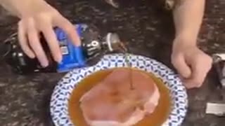 Woman Pours Cola on Pork, Worms Appear in Pork