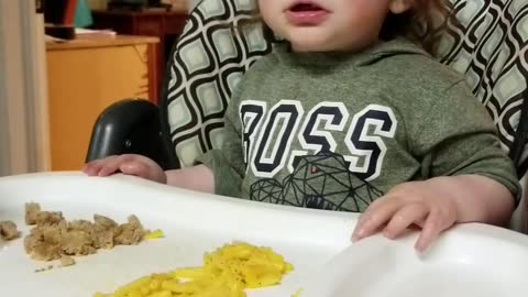 Baby laughs at sister blowing air in a bottle