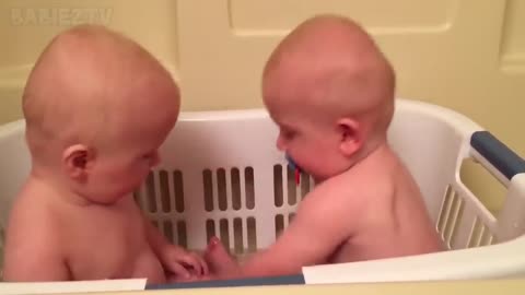 Cute twins share a pacifier👶👶