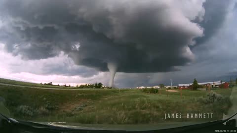 Storm chasing dashcam: Tornado crossing the highway! Laramie, Wyoming