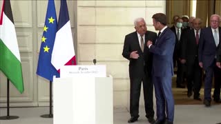 Macron and Abbas enter briefing holding hands