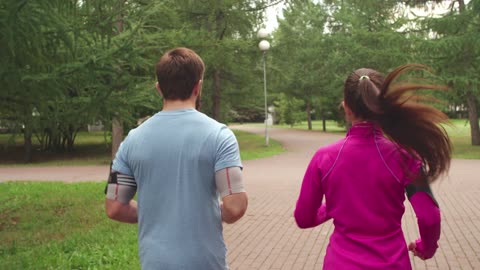 Husband and wife busy in exercise to fit himself