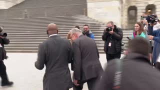 Senator Schumer greets Senator Warnock on the Senate steps