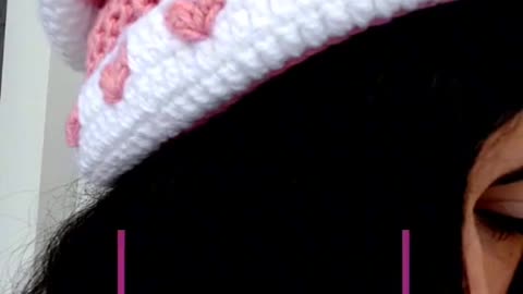 Crochet hat with heart details.