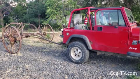 Graham Family Farm: Jeep pulling an Antique Farm Implement