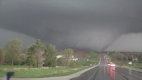 Storm chaser drives into the path of a massive tornado