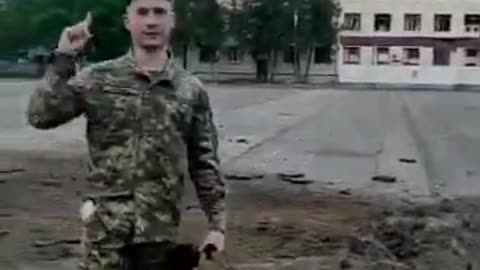 A bomb crater on the parade ground of the 169th training center