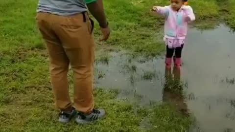 A girl child is fun to have | Look how she persuades her uncle to play in dirty water.