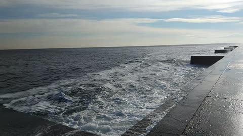 Big sea waves crashing on dam