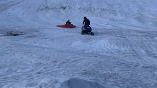 Snowmobile Plunges Passenger into Pond