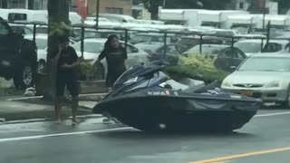 Jetski parked on side of the street