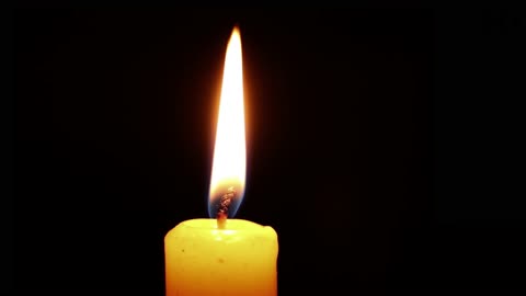 burning candle with black background for memories of your love ones