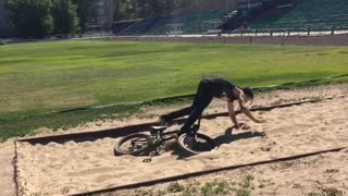 Collab copyright protection - boy on black bike lands in sand pit