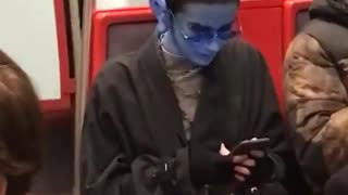 Guy glasses subway blue paint alien long ears