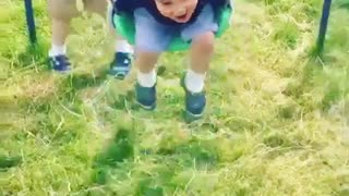 Collab copyright protection - boy pushes boy swing grass faceplant