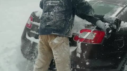 Dad Hilariously Uses Son To Clean Snow Off Car