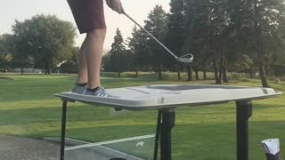 Guy hits golf ball off roof golf cart almost falls