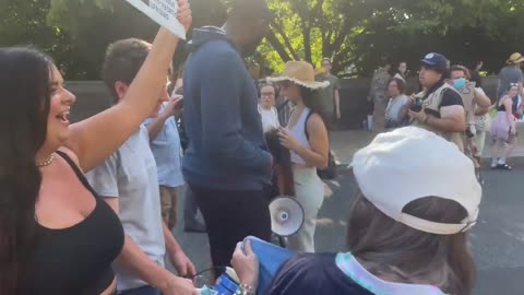 Pro-abortion protester yells misogynistic insults at woman holding a “forceps off their bodies”