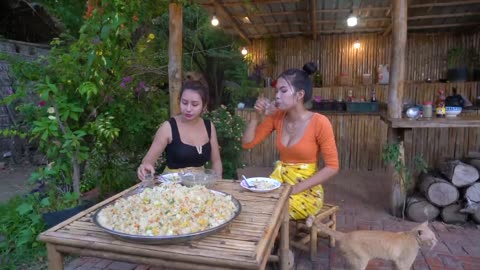 Two sexy girl cooking fried rice in village. Rice fried with egg and vegetable cook recipe .