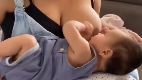 Mom breastfeeding his son