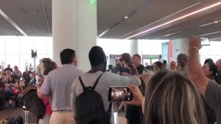 Ted Cruz surrounded by protesters at airport