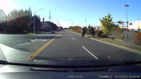 cowboys jaywalking next to the mall