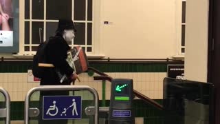 Person carrying stuff with mask and hat in subway station