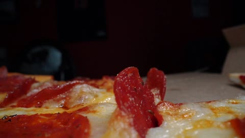 Close Up Footage Of Someone Getting Pizza