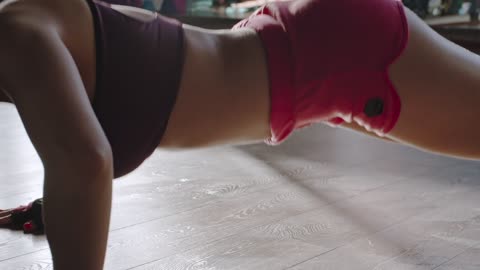 a-woman-doing-push-up-exercise-on-the-floor