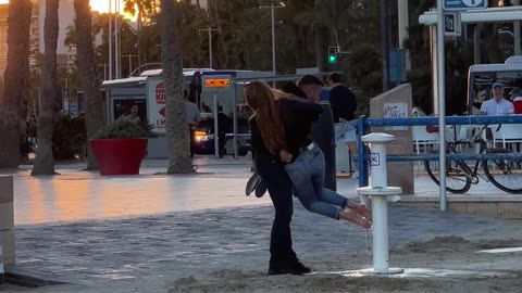 Man Helps His Girlfriend Avoid Sandy Feet