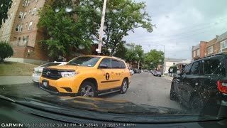 Yellow taxi almost causes an accident.