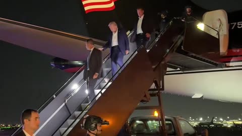 Trump wallking off his plane after the assasination attempt