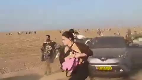 Hundreds of civilians run from an outdoor party after it is attacked by Hamas.