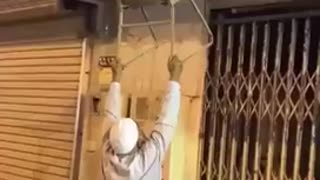 Graban a un anciano haciendo de todo por auxiliar a un gatito varado en el tejado