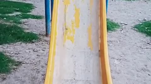Yellow slide in park.